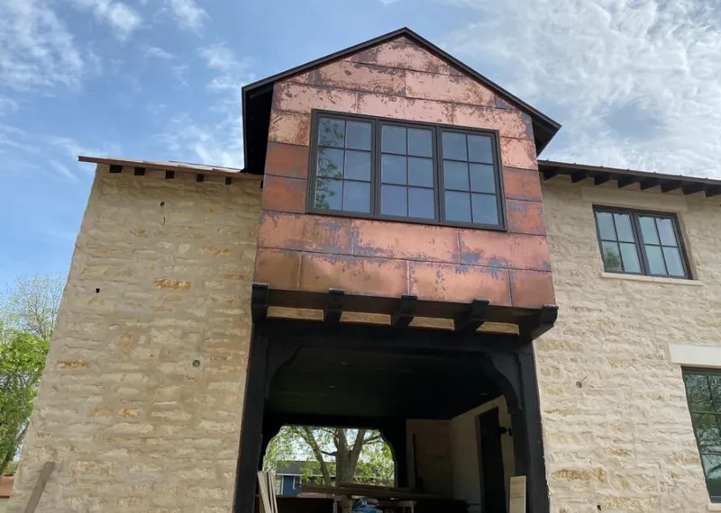 Copper metal panel facade on a stone building for Roof Repair in Caddo Mills